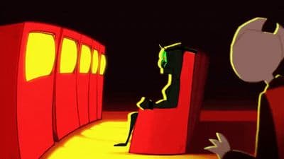 a man sitting in a red chair next to a red train