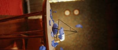 a close up of a clock with blue flowers on it