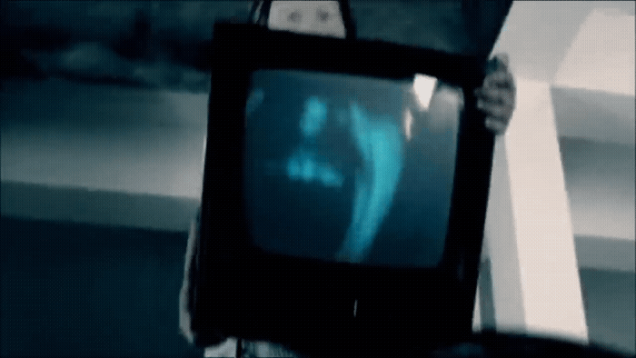 a person holding a television in their hand