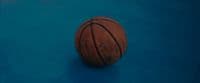 a close up of a basketball on a blue surface