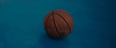 a close up of a basketball on a blue surface