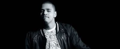 a man wearing a leather jacket and a t - shirt