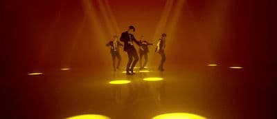 a group of people that are standing in the dark