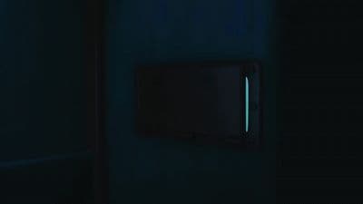 a dark room with a square light switch