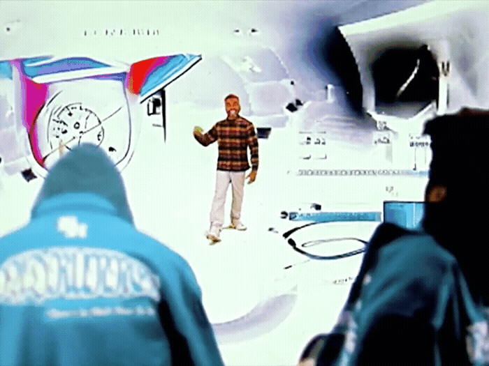 a man standing in front of a tv screen