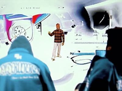 a man standing in front of a tv screen