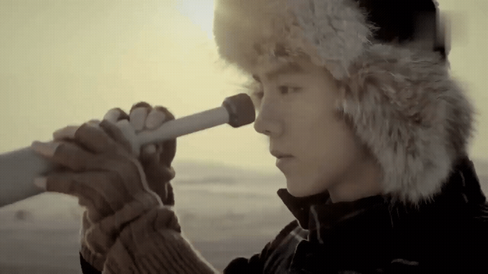 a man in a fur hat looking through a telescope