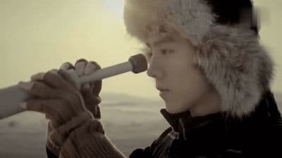 a man in a fur hat looking through a telescope