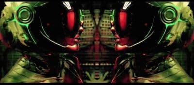a green and red robot with a red light