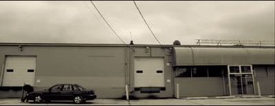 a black car parked in front of a building