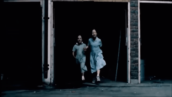 a couple of people that are walking out of a building