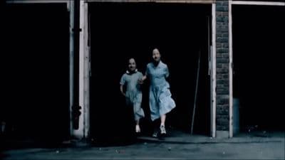 a couple of people that are walking out of a building