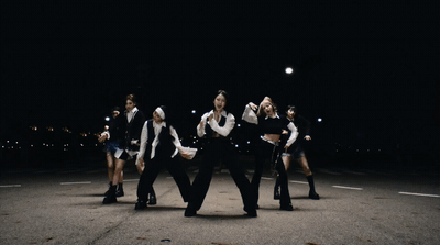 a group of people standing in the middle of a street