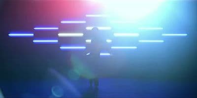 a blurry image of a person standing in front of a wall