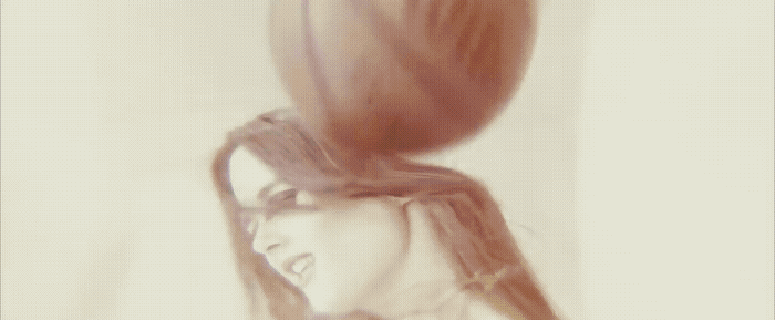 a woman with her hair blowing in the wind