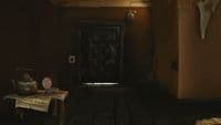 a room with a wooden floor and a black door