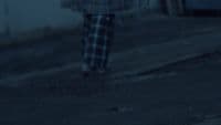 a blurry image of a person walking down a street