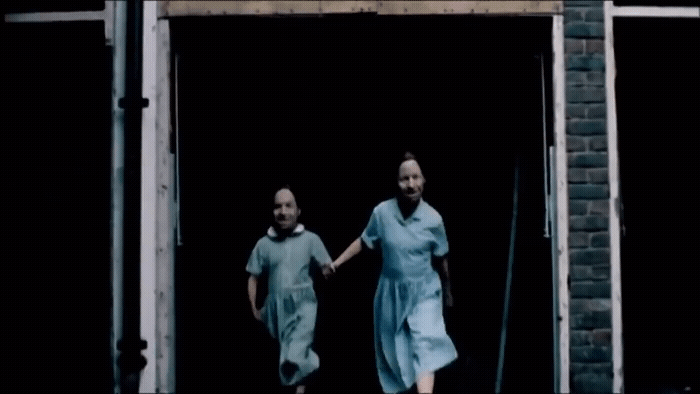 a couple of people that are walking out of a door