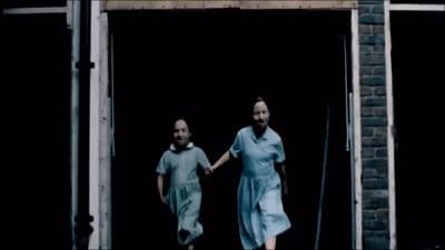 a couple of people that are walking out of a door