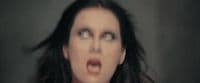 a woman making a face with her hair blowing in the wind