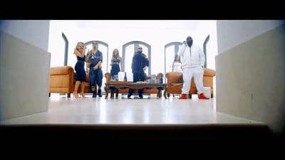 a group of people standing around a living room