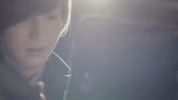 a young man holding a cell phone to his ear