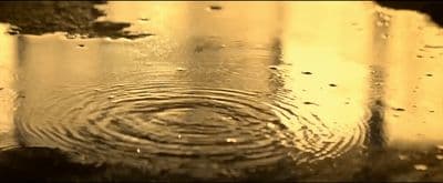 a picture of a rain drop in a puddle
