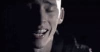 a man with his mouth open in the dark