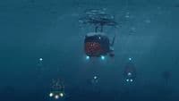 a submarine floating in the ocean with lights on