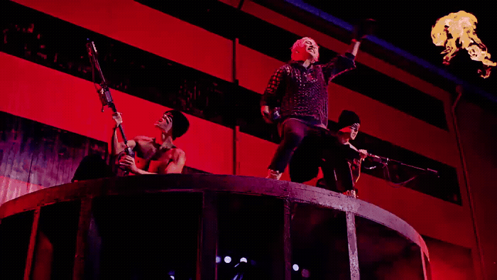a group of people standing on top of a barrel
