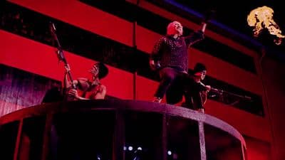 a group of people standing on top of a barrel