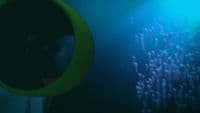a person with a yellow tube in a dark room