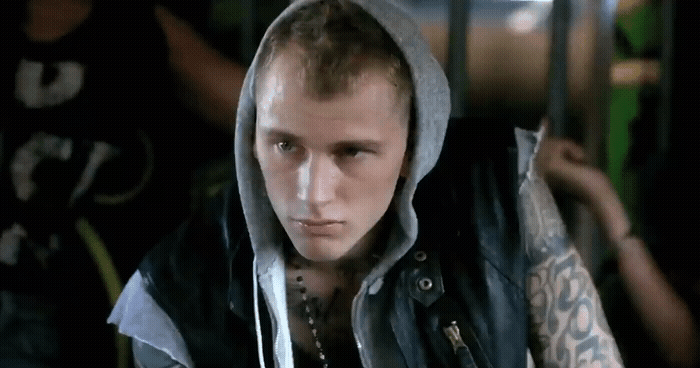a man with a hoodie and tattoos on