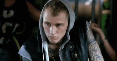 a man with a hoodie and tattoos on