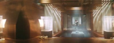 a room with a lot of windows and candles
