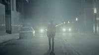 a person standing in the middle of a street at night