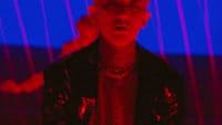 a man in a black jacket and a red and blue background