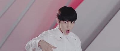 a man in a white shirt pointing at something