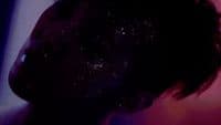 a close up of a person's face with glitter on it