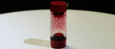 a red tube sitting on top of a white table