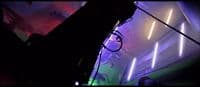 a room filled with neon lights and a neon sign on the wall
