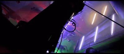 a room filled with neon lights and a neon sign on the wall