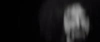 a blurry image of a person standing in the dark