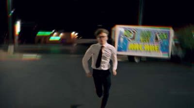 a man in a tie is running down the street