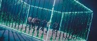 a group of people standing in front of a mirror