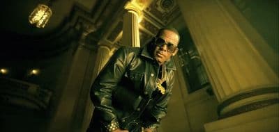 a man in a black leather jacket and sunglasses