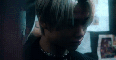 a man with blonde hair and a black shirt