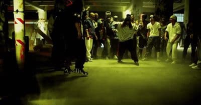 a group of people standing around in a dark room