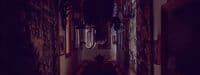 a long narrow hallway with a clock on the wall