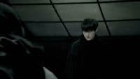 a man standing in a dark room next to a bat